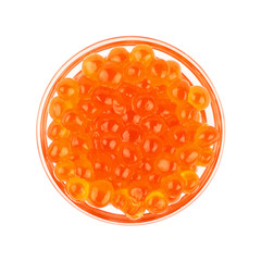 Close up glass bowl of red salmon caviar on white