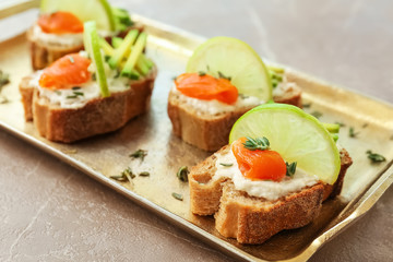 Sandwiches with fresh sliced salmon fillet and avocado on tray