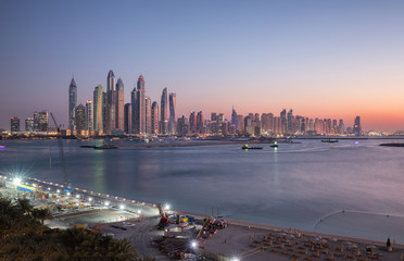Fototapeta premium Skyline of Dubai Marina at sunset with a beautiful beach in the foreground