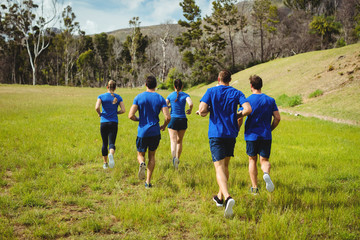 Fit people running in boot camp