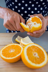 Naklejka na ściany i meble Woman peeling orange
