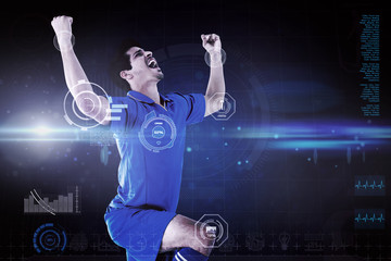 Cheering football player against blue dots on black background