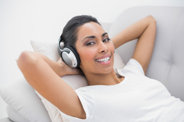 Content smiling woman listening to music smiling at camera 