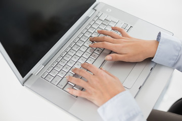 Close up of hands using laptop