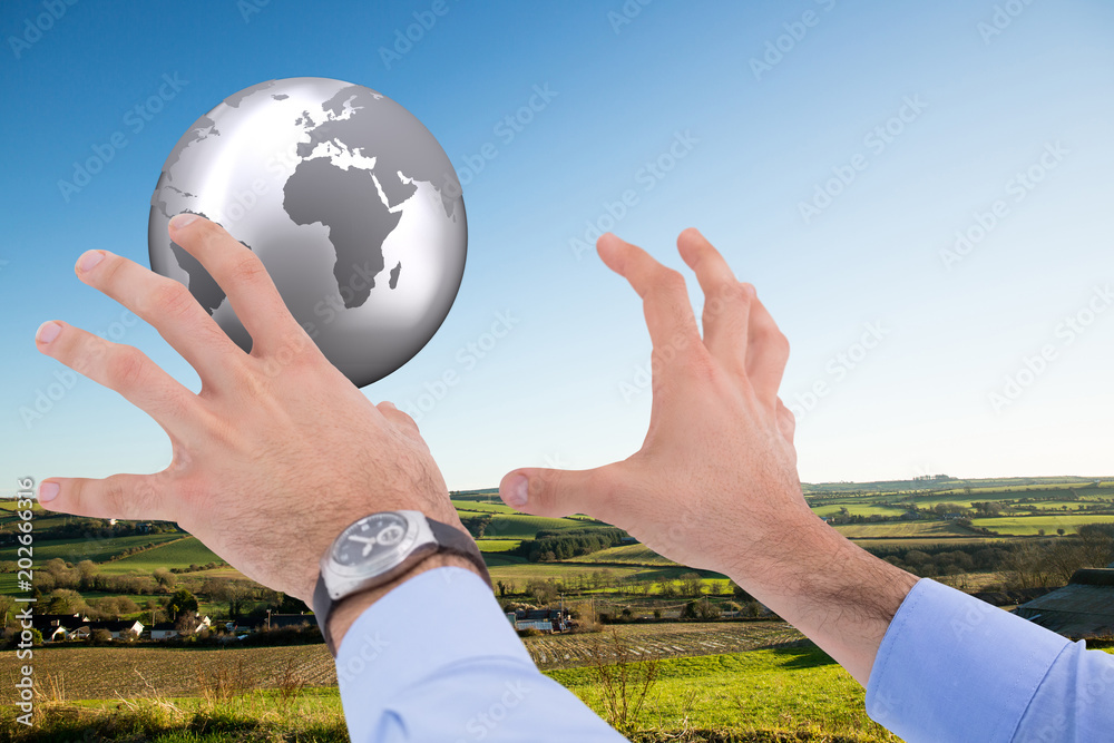 Canvas Prints Businessman holding something with his hands against scenic landscape