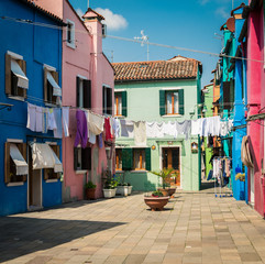 Fototapeta na wymiar Colorful houses by canal in Burano, Venice, Italy.
