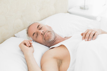 Fototapeta na wymiar Mature man sleeping in bed at home