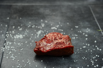 Raw beef fillet steaks with spices on on a stone background
