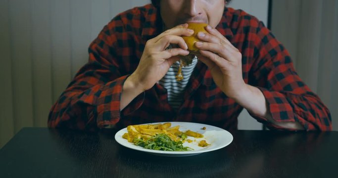Hipster man eating a hamburger