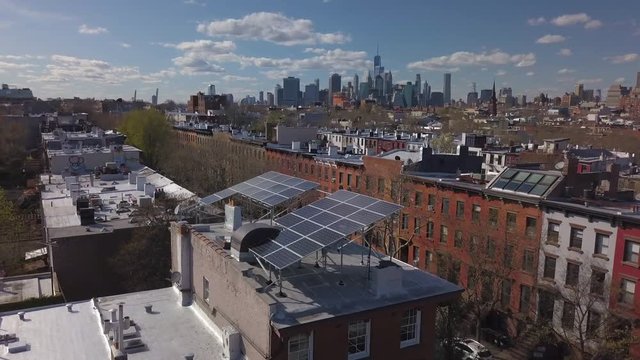 day flying counter clockwise around solar panels on Brooklyn brownstone