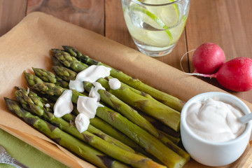 Asparagus with dip on board.