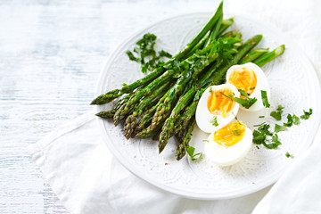 Roasted Green Asparagus and Boiled Eggs with Fresh Herbs on a Plate