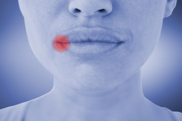 Woman with luscious lips against grey vignette