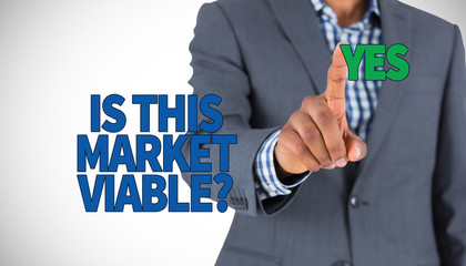 Focused businessman pointing against white background with vignette