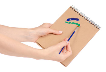 Notepad for drawing and brush with paint in hand