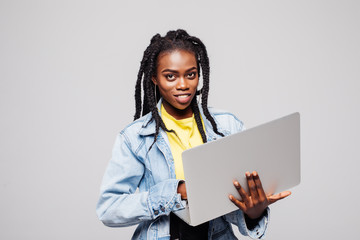 Portrait of smiling young afro american woman using laptop isolated over white background