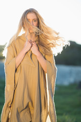 Blonde woman posing in front of camera