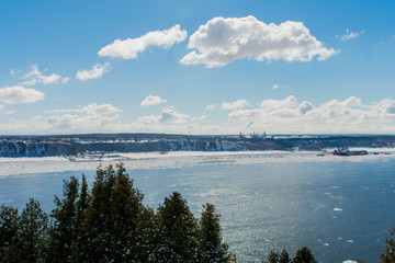 A beautiful view of a river on a sunny, cold day in a park