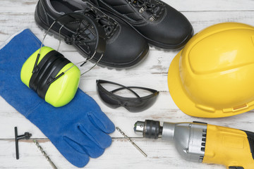 Standard construction safety equipment and Tools on wooden table. top view