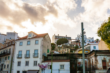 Fototapeta na wymiar Old Lisbon Portugal steet. cityscape with roofs. Tagus river. miraduro viewpoint
