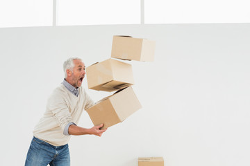 Side view of a mature man carrying boxes