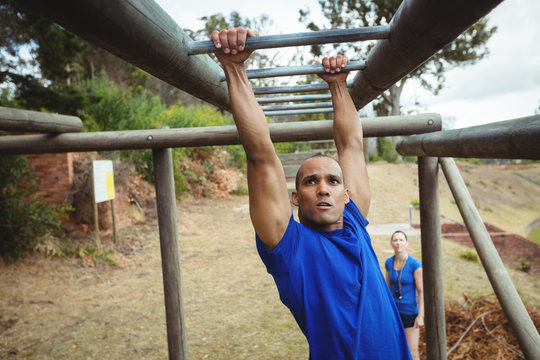 Fit Man Climbing Monkey Bars