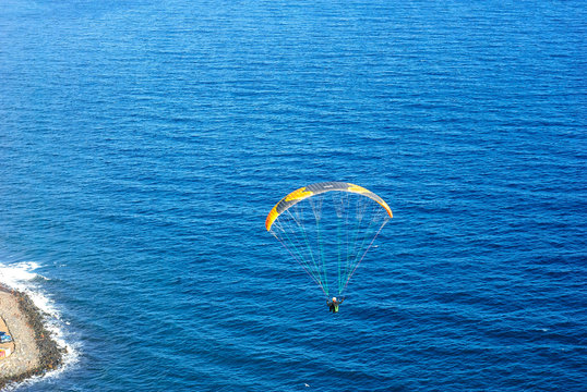 Far away Paraglider near the beach of Las Gaviotas. Tenerife, Canary Islands.