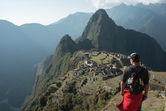 Top View Of Man Looking Out At Machu Picchu Peru