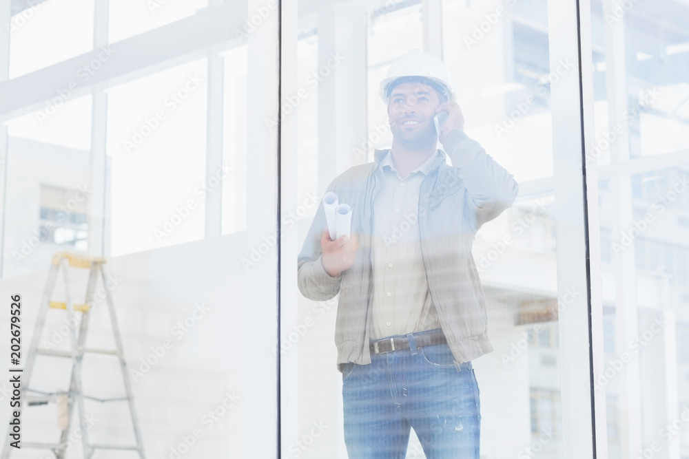 Wall mural architect using mobile phone in office