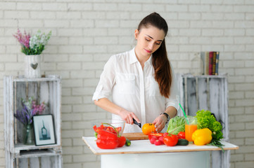 Young Woman Cooking. Healthy Food - Vegetable Salad. Diet. Healthy Lifestyle. Cooking At Home. Prepare Food