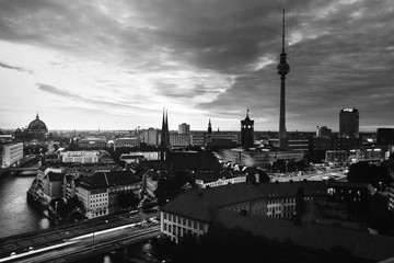 Illuminated landmarks in Berlin, Germany in the morning. Colorful cloudy sky at sunrise. Black and white