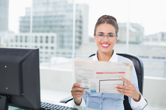Smiling brunette businesswoman holding documents
