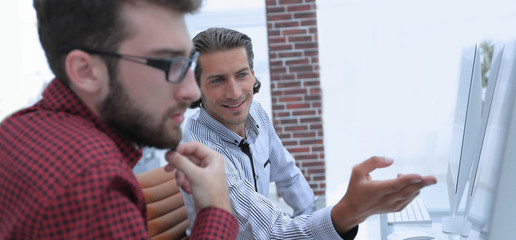 employees sitting behind a Desk