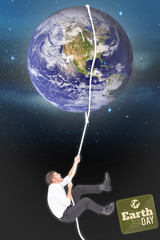 Businessman pulling a rope against stars twinkling in night sky