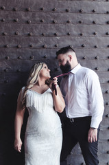 Woman leading a man by his tie