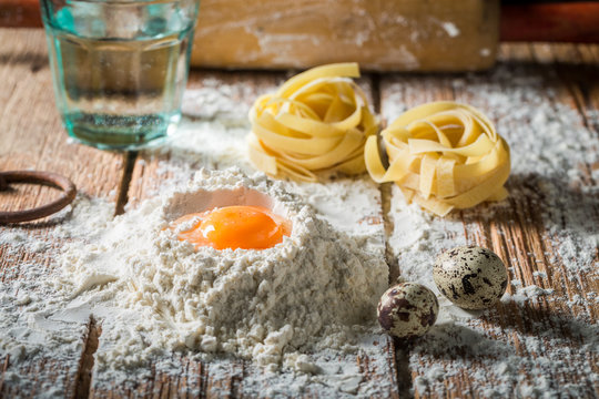 Closeup of fresh ingredients for pasta with flour and eggs