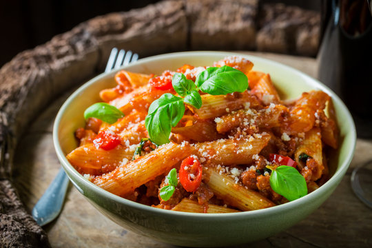 Delicious penne bolognese with red wine and parmesan