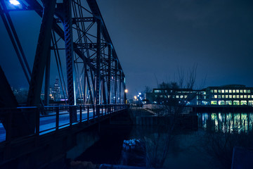 Vintage industrial railroad bridge crossing the Chicago river at night