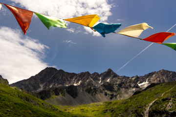 Nepalese prayer flags and mountainrange in Austria