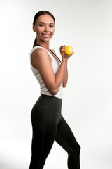 Sport life concept. Portrait of sender woman posing with dumbbells in arms and looking at camera...