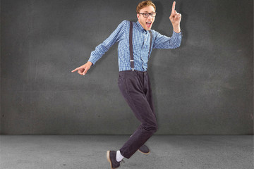 Geeky hipster dancing to vinyl against grey room