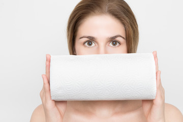 Beautiful woman is holding kitchen roll in front of her face