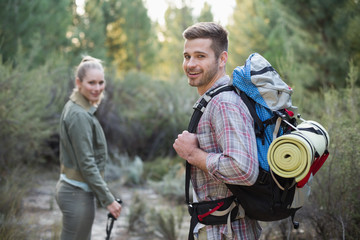 Fit young couple exploring the woods