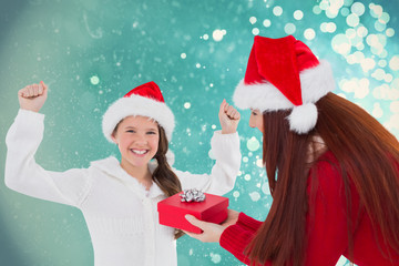 Mother and daughter with gift against light design shimmering on blue