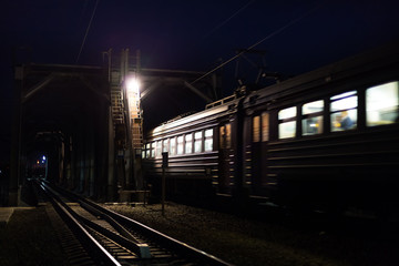 Passenger Train is passing over bridge at night