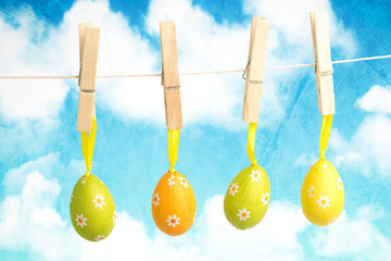 hanging easter eggs against painted sky and clouds