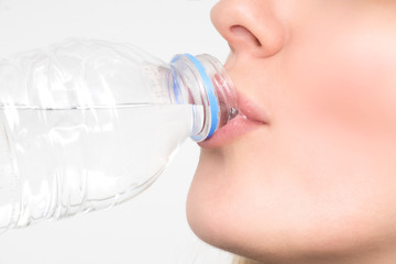 Woman drinks water from the bottle