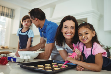 Happy family preparing cookies in kitchen 