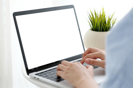 Woman hands typing laptop computer with blank screen for mock up template background, top view, business technology and lifestyle background concept