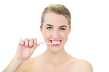 Attractive blonde brushing her teeth